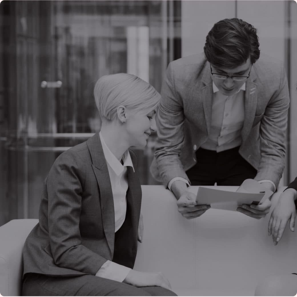 Two USIF colleagues going through paperwork in a meeting room