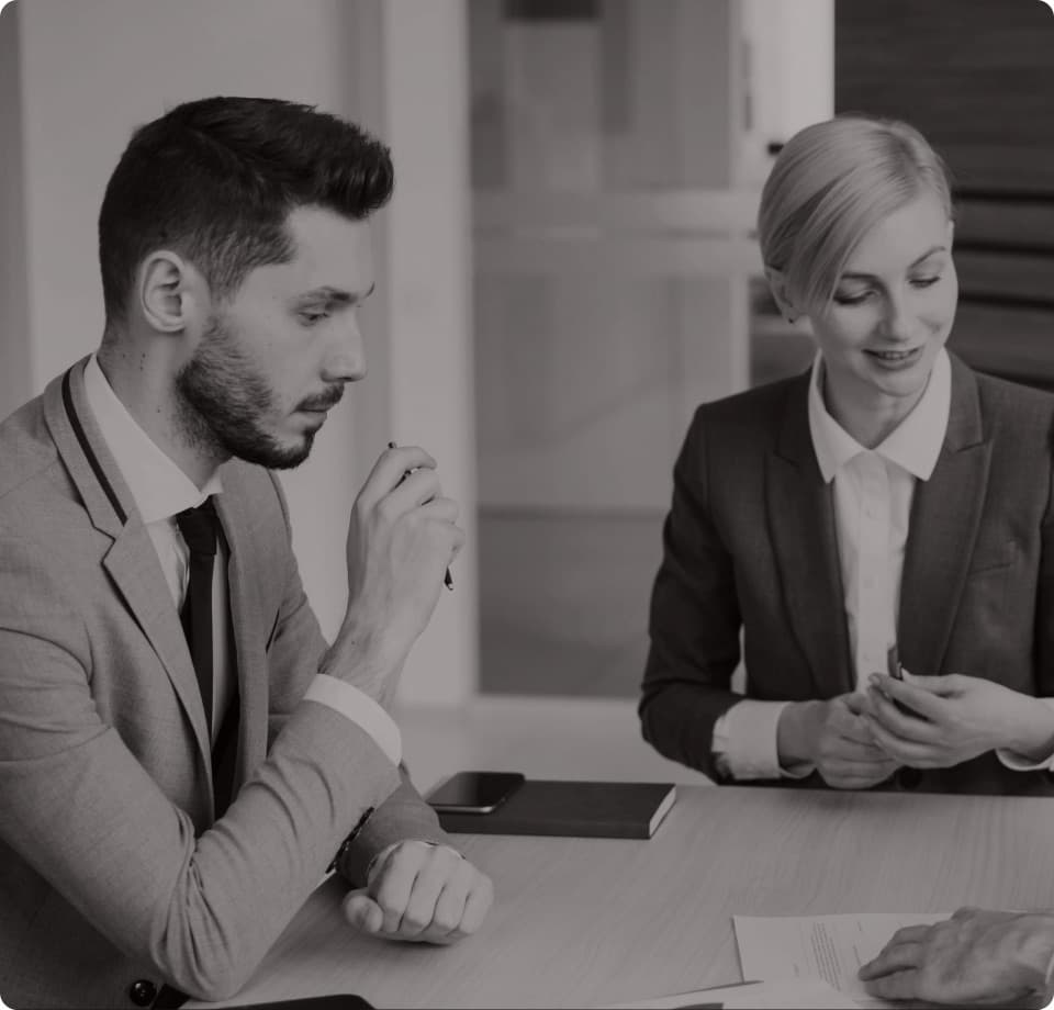Two USIF advisers in conversation across a desk