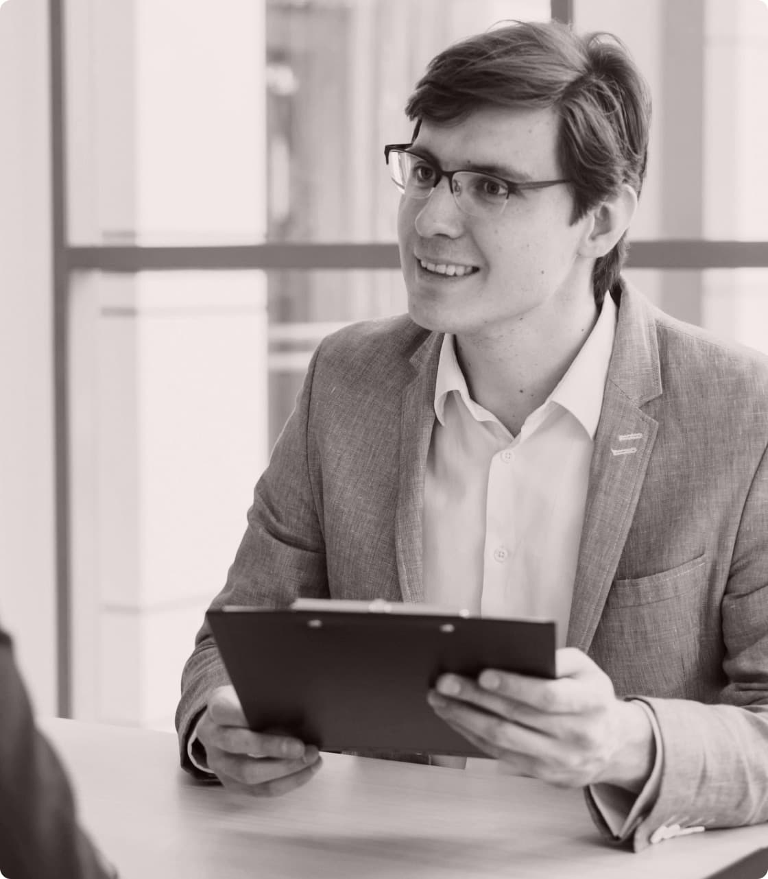 An agent reviewing account documents on a clipboard